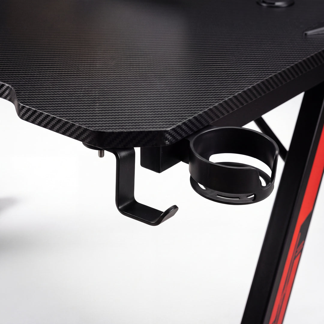 Z-shaped gaming desk detail, the headphone hook and cup holder mounted under the carbon fibre look desktop edge